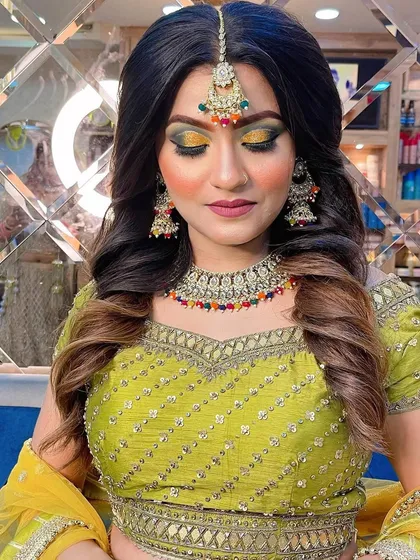 A close-up of the vibrant Haldi makeup, showing the beautiful blend of yellow and green eyeshadow and the flawless finish on the skin.