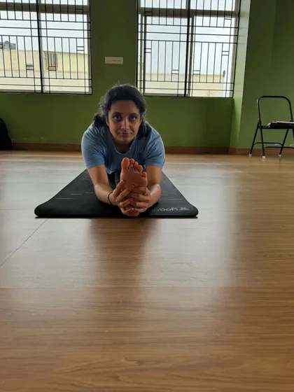 A close up of the forward fold in a split, showing the student's focus and the depth of the stretch. Every practice brings you closer to your goals.