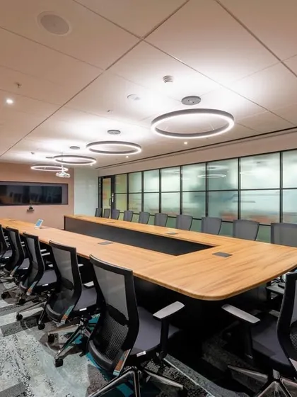 We designed this corporate boardroom with a focus on texture and pattern. The angled wood paneling on the wall is complemented by the geometric design of the carpet, making the room interesting without being distracting.