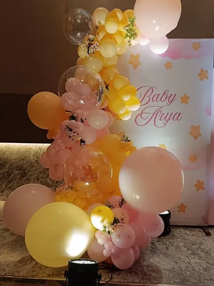 A close-up of the intricate balloon work for Baby Arya's party, mixing large and small balloons with clear bubble balloons for a sophisticated look.
