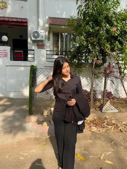 A formal, all-black look. This shows a more serious and professional side to my artistic persona.