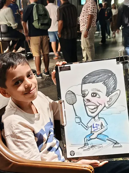 This young boy is a badminton player, so I drew him with a racquet in hand. I can customize caricatures to include hobbies and interests.