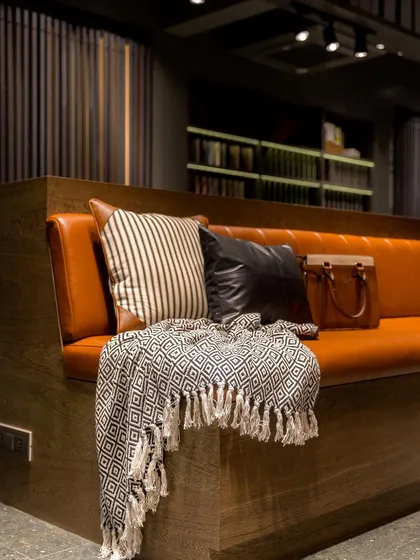 A close-up of the comfortable seating area, where rich leather and soft textiles invite clients to relax and stay a while.