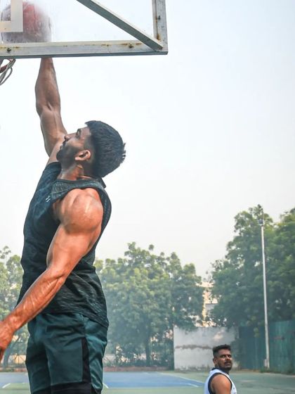 Work hard in silence. Let your success be your noise. A powerful shot of a player dunking during a workout.