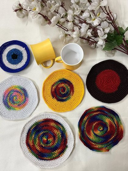 This image shows a variety of my coaster designs, including the evil eye, rainbow swirls, and solid colors, demonstrating the range of styles I can create for your table decor.