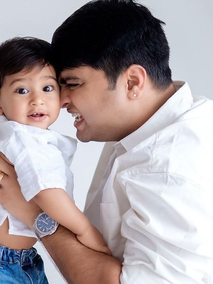 A close-up of a father and son sharing a happy, interactive moment.