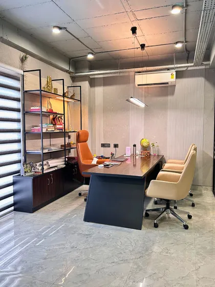 A private cabin in the Gurugram office, featuring a minimal yet refined aesthetic. The space includes a sleek desk, ergonomic chairs, and an open shelving unit for a look that is both sophisticated and highly efficient.