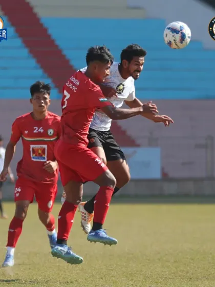 An intense aerial battle as our player challenges for a header in a crowded penalty area.