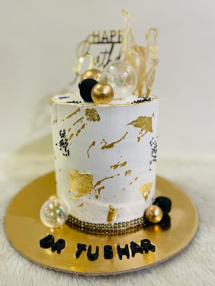 A full view of the elegant tall cake, perfect for a sophisticated birthday celebration for someone like a doctor.