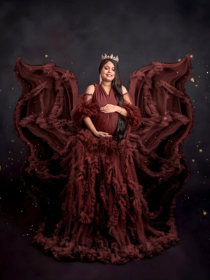 Feeling like an angel. The ruffled maroon gown is styled to create beautiful, wing-like shapes, giving this portrait a dramatic and enchanting feel. I love bringing a client's vision to life.