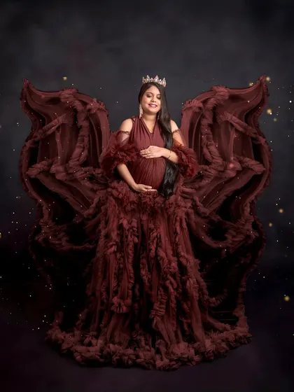 Feeling like an angel. The ruffled maroon gown is styled to create beautiful, wing-like shapes, giving this portrait a dramatic and enchanting feel. I love bringing a client's vision to life.