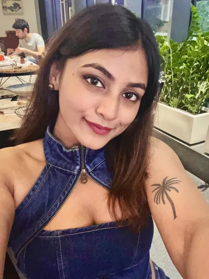 A close-up selfie of the denim-on-denim look. The halter top's unique cut makes it a statement piece.
