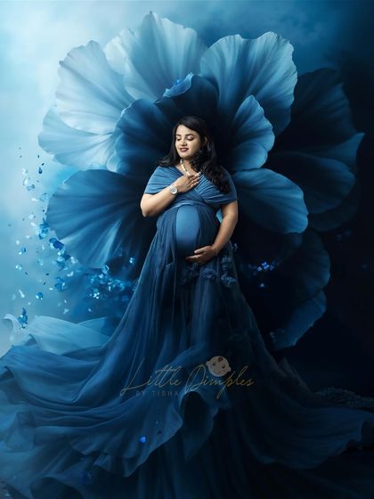 Blooming in blue. The combination of a gorgeous blue gown and a giant floral backdrop creates a striking and artistic image that is full of grace.