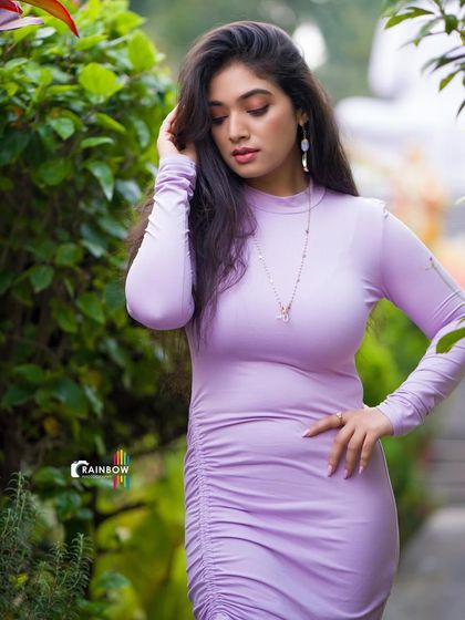 A close-up of Priyanka Thimmesh in the garden, focusing on her thoughtful expression and the beautiful natural light.