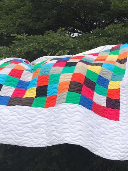 Another view of the colorful quilt outdoors.