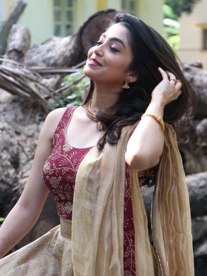 This candid photo captures a moment of pure bliss. The hair is styled with natural waves, and the makeup is light and fresh.