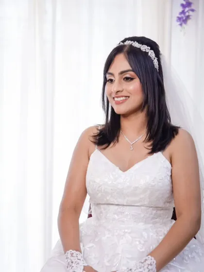 A happy, smiling bride ready for her big day. Her makeup is light and fresh, perfect for a daytime wedding, letting her natural beauty be the focus.