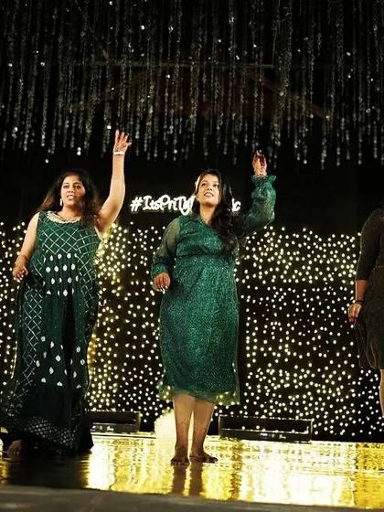 The bride and her cousins rocking the stage. Group dances are a fantastic way to include all your loved ones in the celebration.