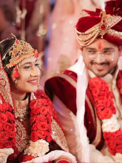 A candid shot of the bride and groom during their ceremony. The groom's loving smile towards his bride captures a genuine, unscripted moment of happiness.