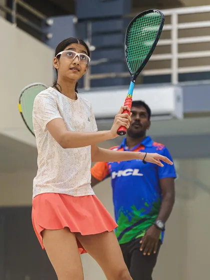 A great shot showing a coach observing his student, Samairah Bhandare. This image provides a glimpse into the training and guidance that shapes a young athlete's career.