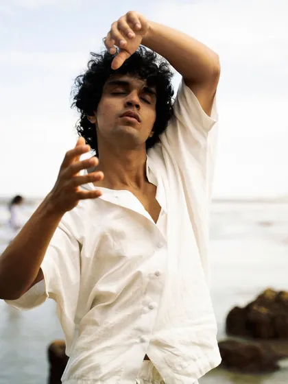 This series showcases a male model interacting with the natural beach environment. From the water to the rocks, each shot captures a different mood, perfect for an editorial story.