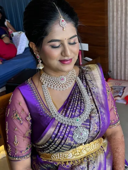 For this beautiful mom-to-be's Seemantham, we went for a soft, glowing look. The makeup is subtle, enhancing her natural pregnancy glow with gentle pink tones on the eyes and lips, ensuring she felt comfortable and radiant.