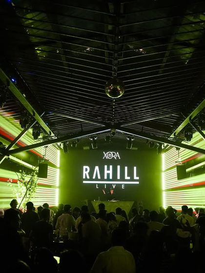 A laser light show illuminates the crowd at Xora Hyderabad. I utilize advanced lighting effects like lasers to elevate the clubbing experience and create a festival-like feel.