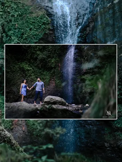 A wide-angle shot of the couple standing by a cascading waterfall in Shimla. This photo captures the grandeur of the location and the adventurous spirit of the shoot.