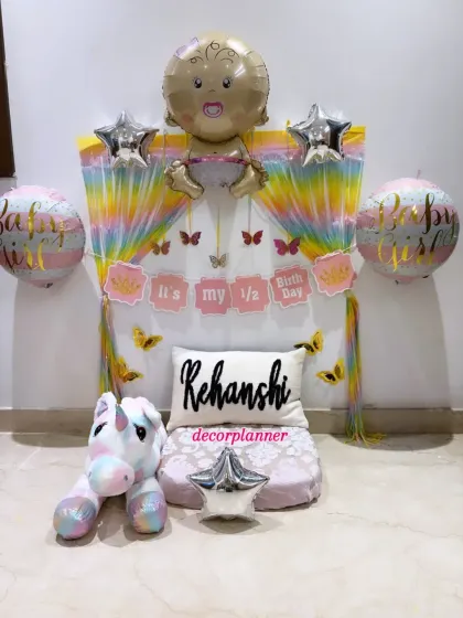 Another view of the adorable half-birthday decor, highlighting the 'It's my 1/2 Birthday' banner and the large baby-shaped foil balloon at the top.