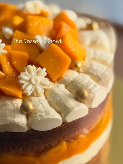 Another detail shot of the mango cake, focusing on the delicate decorations on top.