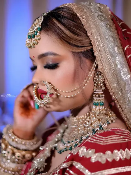 A soft and elegant close-up, capturing the details of the bride's makeup and jewelry.