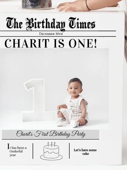 A creative prop from a first birthday shoot, featuring a custom 'The Birthday Times' newspaper announcing that the baby is one.