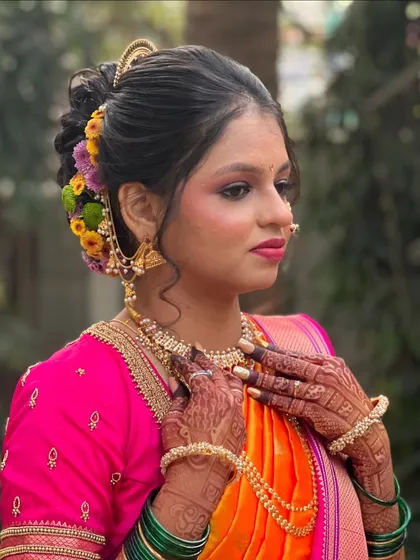 My bride Siddhi looking gorgeous in her orange and pink saree, with a beautiful floral bun.