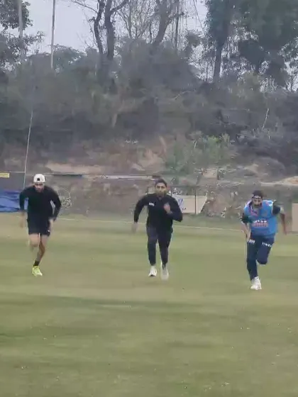 A high-speed chase drill on the field. This type of reactive agility work improves an athlete's ability to track opponents or the ball, change direction quickly, and accelerate in pursuit.