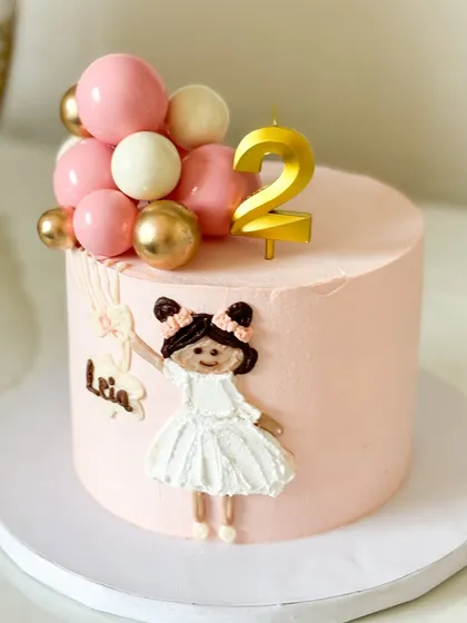 Bringing a client's vision to life with this stunning hand-painted doll cake. This Jain-friendly cake features a beautiful, handcrafted figure for Leia's second birthday.