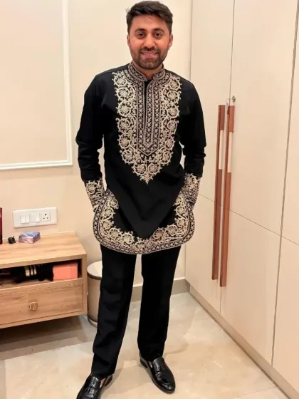 The full view of the black and gold short kurta, a modern take on festive wear.