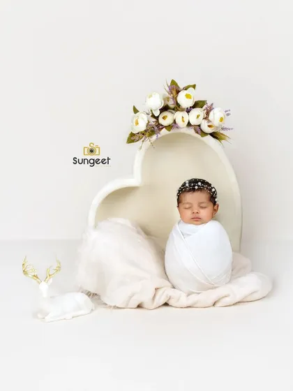 A classic potato sack pose in our heart-shaped bowl. This pose is perfect for showing off a newborn's sweet, curled-up form in a simple and beautiful way.