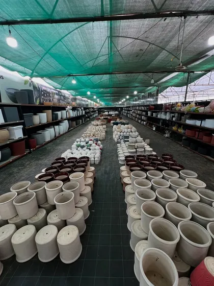 A wide-angle view of our pot showroom. The aisles are packed with thousands of pots, ensuring that nurseries, landscapers, and retail customers can find exactly what they need in bulk.