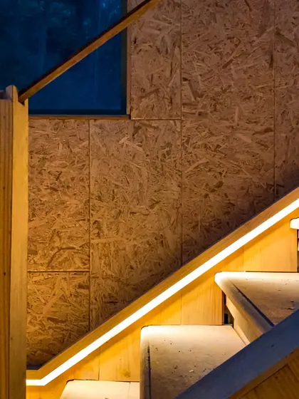 Attention to detail is key in our work. Here, integrated LED lighting along the wooden staircase provides both safety and a warm, modern ambiance, highlighting the clean lines of the design.