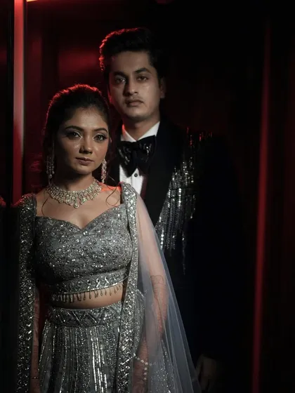 An evening of elegance and love. This portrait captures the couple's sophisticated style for their Sangeet celebration.