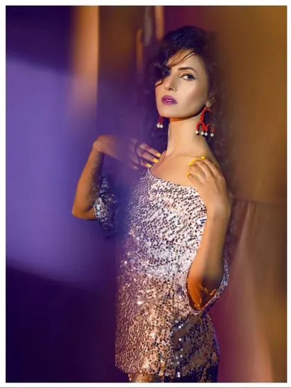 A creative, artistic shot highlighting the texture and shine of the silver sequin top. This kind of party wear is designed to catch the light and turn heads.