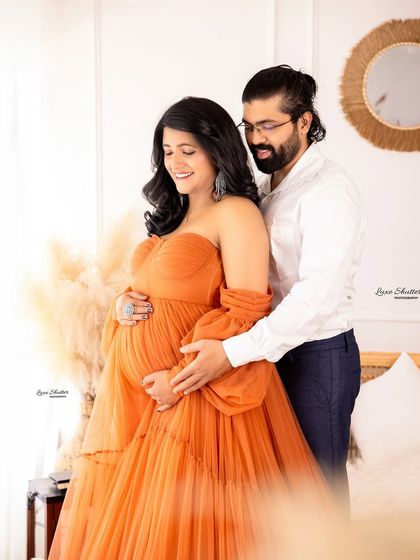 A close-up of the happy couple. Capturing these moments of shared smiles and gentle touches is what makes a couple's maternity session so special.
