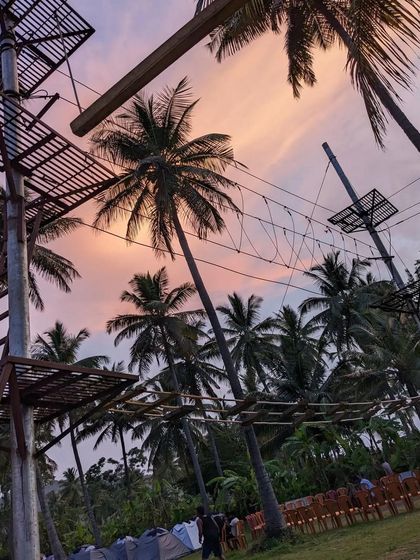 The rope adventure course set against a beautiful sunset sky. It's a different way to enjoy the view.