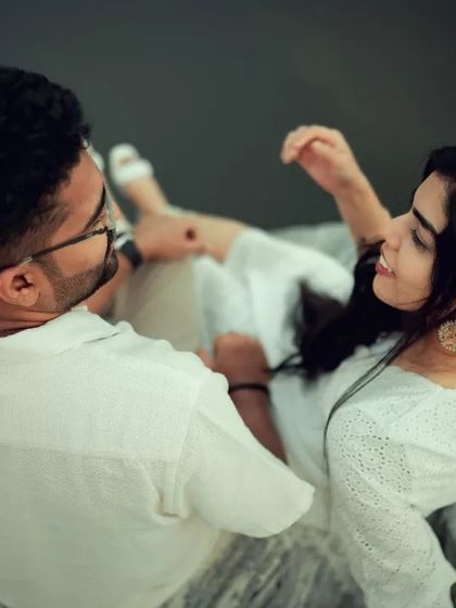 An overhead shot of a couple relaxing by the water, creating a unique and artistic perspective. We experiment with different angles to make your photo gallery diverse and interesting.