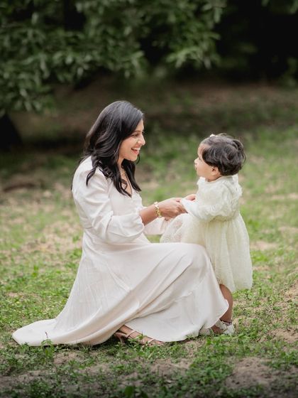 A mother and daughter sharing a sweet moment during an outdoor photoshoot.