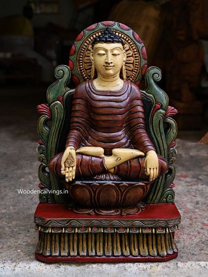 A 24-inch Buddha sculpture with an ancient look, seated on a brown lotus. The hand-painted finish uses a palette of deep reds and greens to create a sense of timeless serenity.
