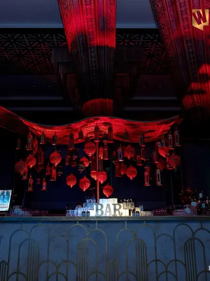 This is an example of a grand, atmospheric bar we designed for a wedding at the Hilton Salwa Beach Resort in Doha. The dramatic red lighting and hanging lanterns created a truly immersive and luxurious experience.