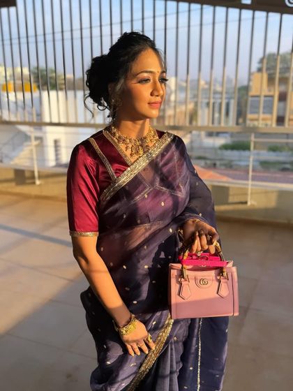 The golden hour light beautifully highlights the texture and detail of this elegant updo.