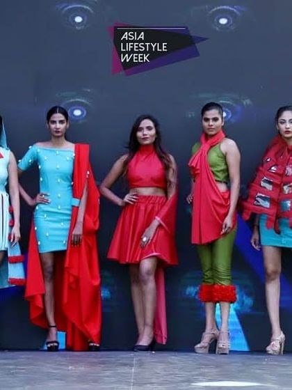 Our students' collection on the ramp at Asia Lifestyle Week. This lineup displays a unified theme using a palette of red and blue, with each outfit exploring different silhouettes, from structured dresses to draped ensembles.