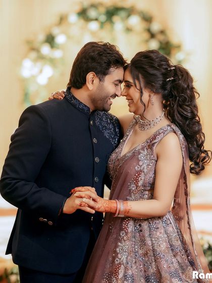 A joyful and intimate portrait of a couple on their engagement day. Their genuine smiles and foreheads touching create a picture of pure happiness and love.